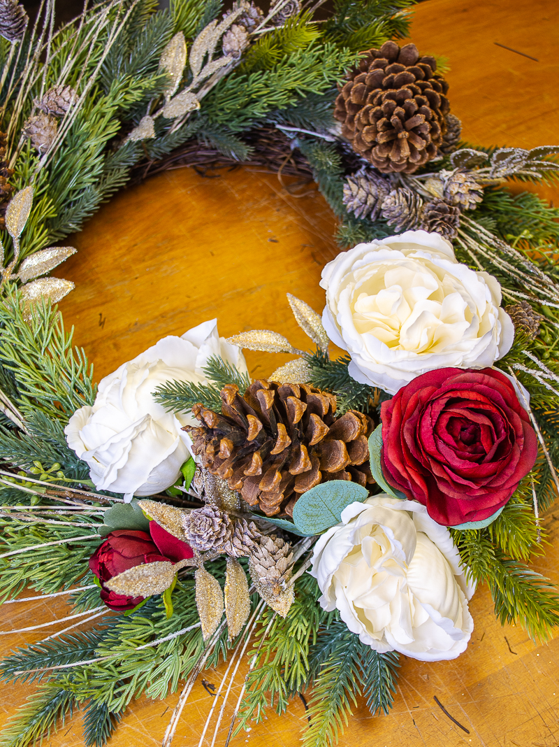 Bottom of wreath with three white blooms and two red