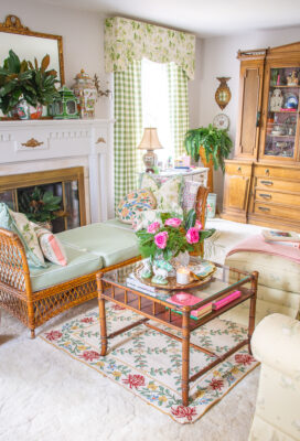 Katherine's traditional living room decorated in greens, white, and pink with antiques, wicker, and needlepoint
