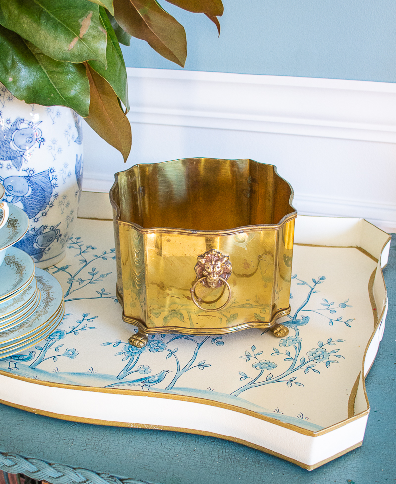 Classic tableware essentials: keep a variety of vessels for flowers like this brass lion head caddy