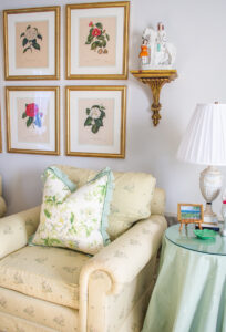 Waverly chintz on armchairs with botanical prints above