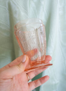 Pink Depression glass goblet with floral motif