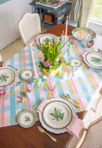 A plaid pastel Easter table with lily of the valley dishes