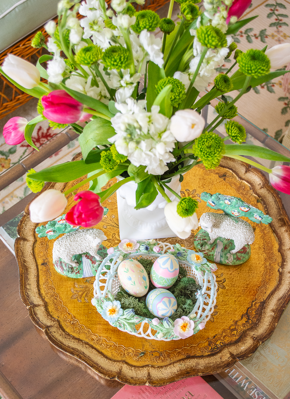 Spring vignette on the coffee table with gold tray, Staffordshire sheep, fresh flowers, and reticulated basket with Easter eggs