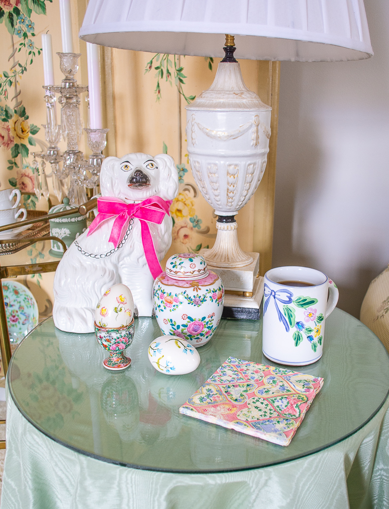 End table with spring decor including pink floral ginger jar, floral Easter eggs, and pretty coffee mug
