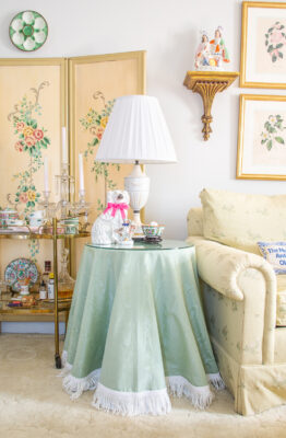 A budget friendly trick to get the look of the skirted table - here used green moire fabric and white bullion fringe