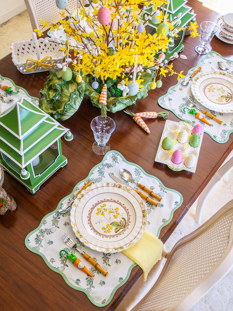 Green and yellow spring tablescape with yellow bell centerpiece, pagoda lanterns, and Spode Wicker Dell dishes