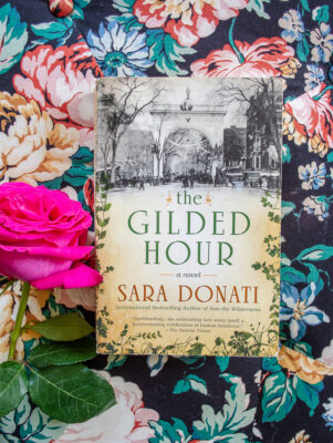 Book on floral fabric with pink rose - The Gilded Hour by Sara Donati