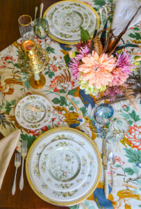 Welcome fall with a Chinoiserie inspired tablescape filled with elegant china, sparkling metallics, lush fabrics, and colorful florals.