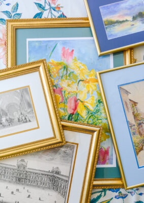 Tips for traditional framing: flat lay of art works on paper framed in gold frames from Frame It Easy