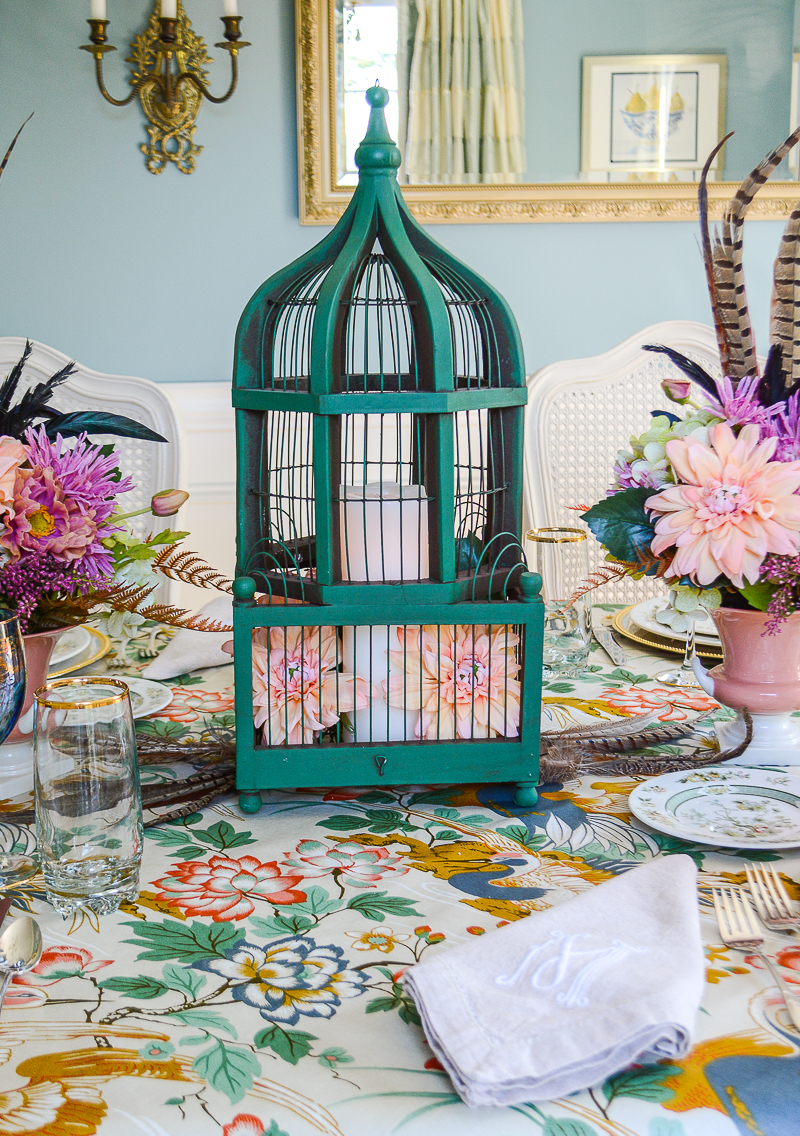 A whimsical fall centerpiece idea - vintage birdcage filled with flowers and candles.
