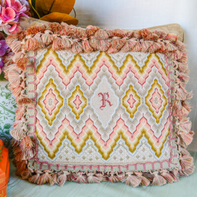 Shop this colorful pink and green bargello needlepoint pillow with "R" monogram on Curio Collected.