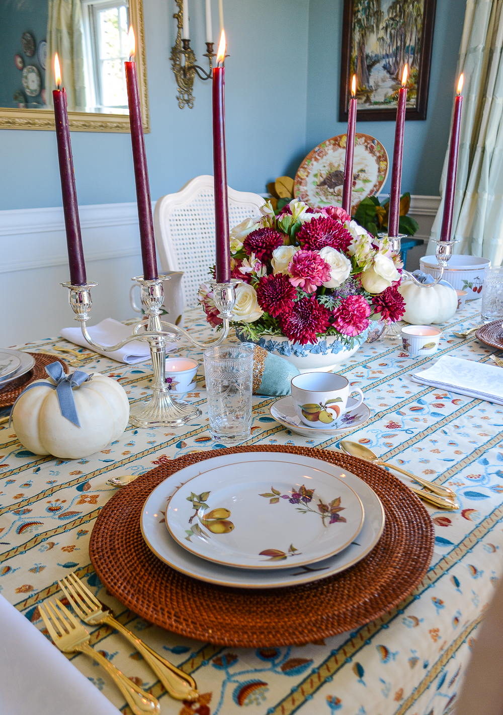 Royal Worcester Evesham dishes with fruit create a lush look on this Grandmillennial Thanksgiving tablescape with brown and blue linen from Schumacher