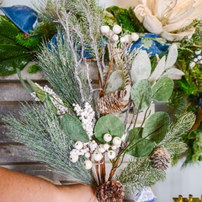A glittered winter spray with eucalyptus, pinecones, white berries, and pine.