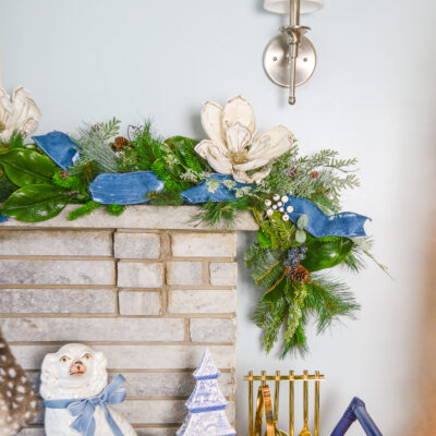Shop this frosted garland featuring a wintery iced mix of pine, cedar, juniper, and magnolia. It is perfect for the mantel or stairs.