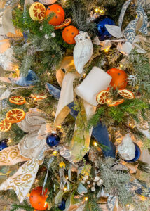 The multifaceted blue and white Christmas tree is a lovely backdrop to so many different colors and themes. Learn more on penderandpeony.com