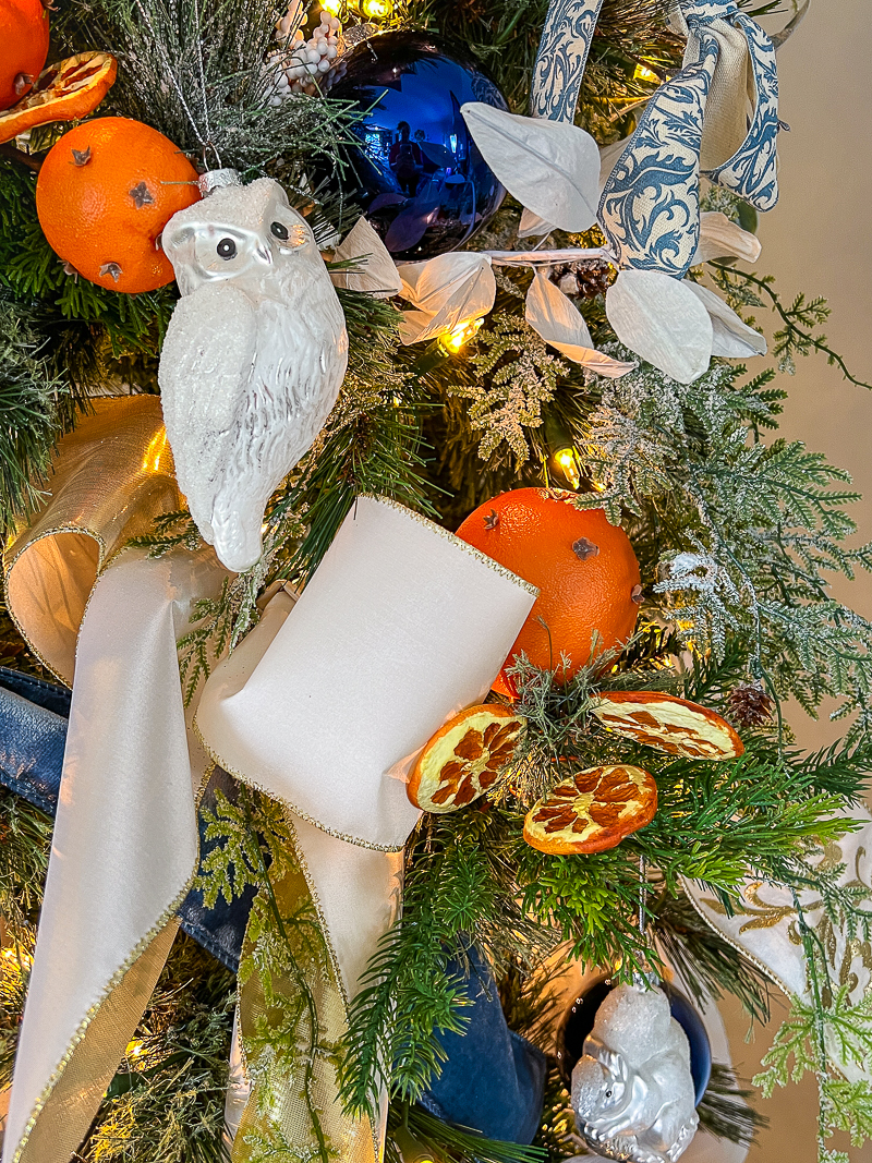 A Williamsburg inspired Christmas tree with dried oranges works beautifully with a blue and white backdrop on your tree.