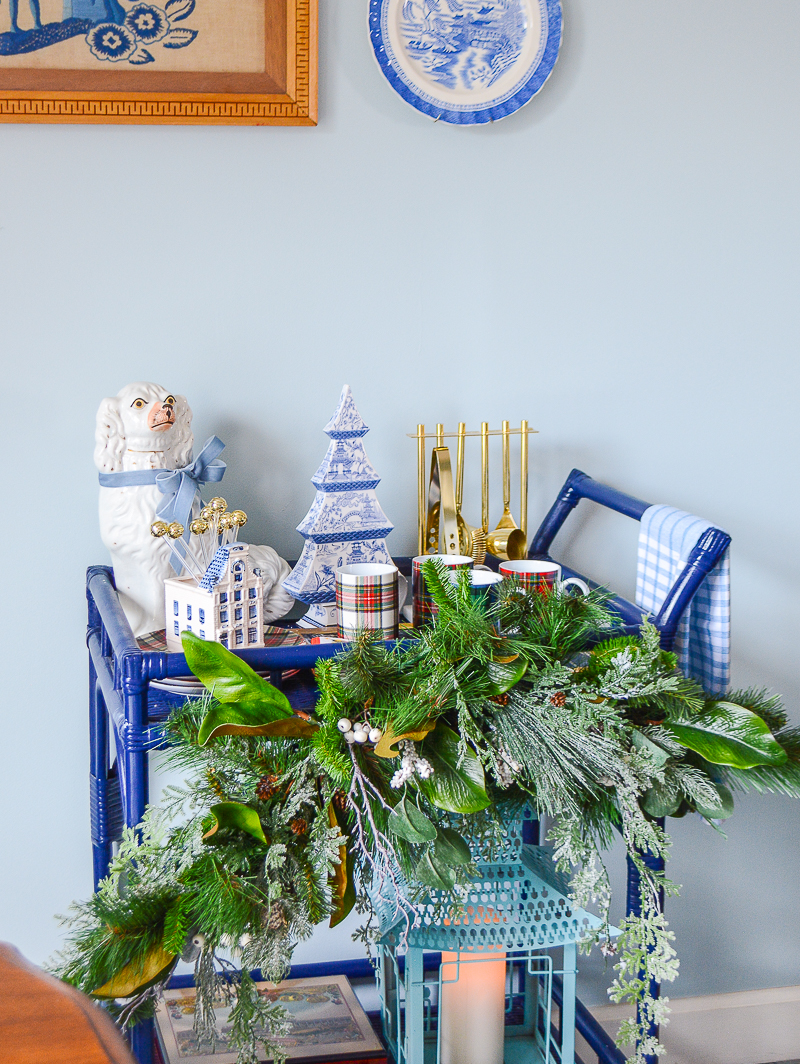 A winter themed holiday bar cart in blue and white.