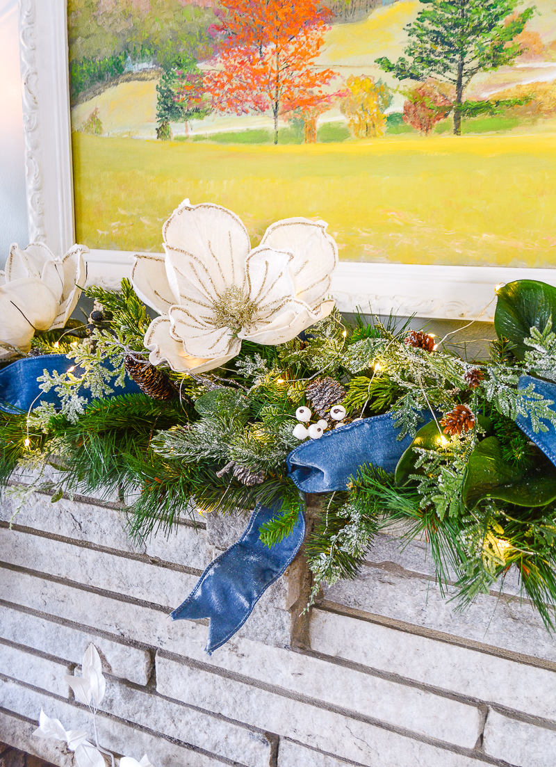 A glittered felt magnolia adds interest to this frosted winter garland in Katherine's den.