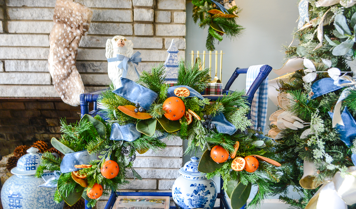 Blue and white Christmas look with orange pomanders, velvet ribbon, Chinoiserie, and frosted pine.