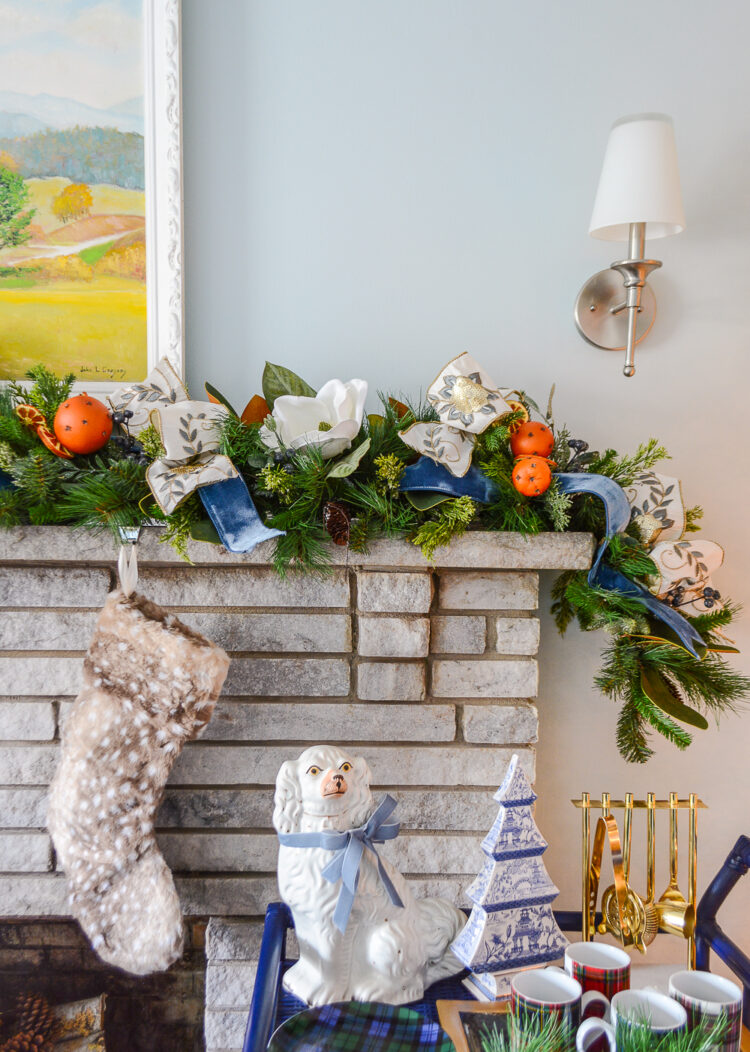 Shop this one of a kind garland for a very merry mix of magnolia, pine, orange pomanders, and ribbon for your holiday mantel!