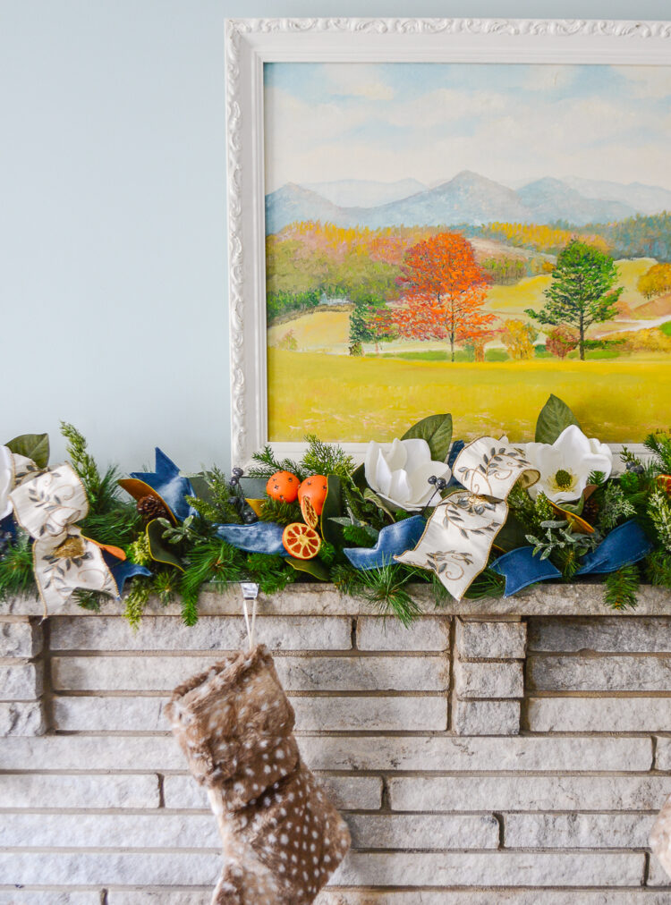 Shop this one of a kind garland for a very merry mix of magnolia, pine, orange pomanders, and ribbon for your holiday mantel!
