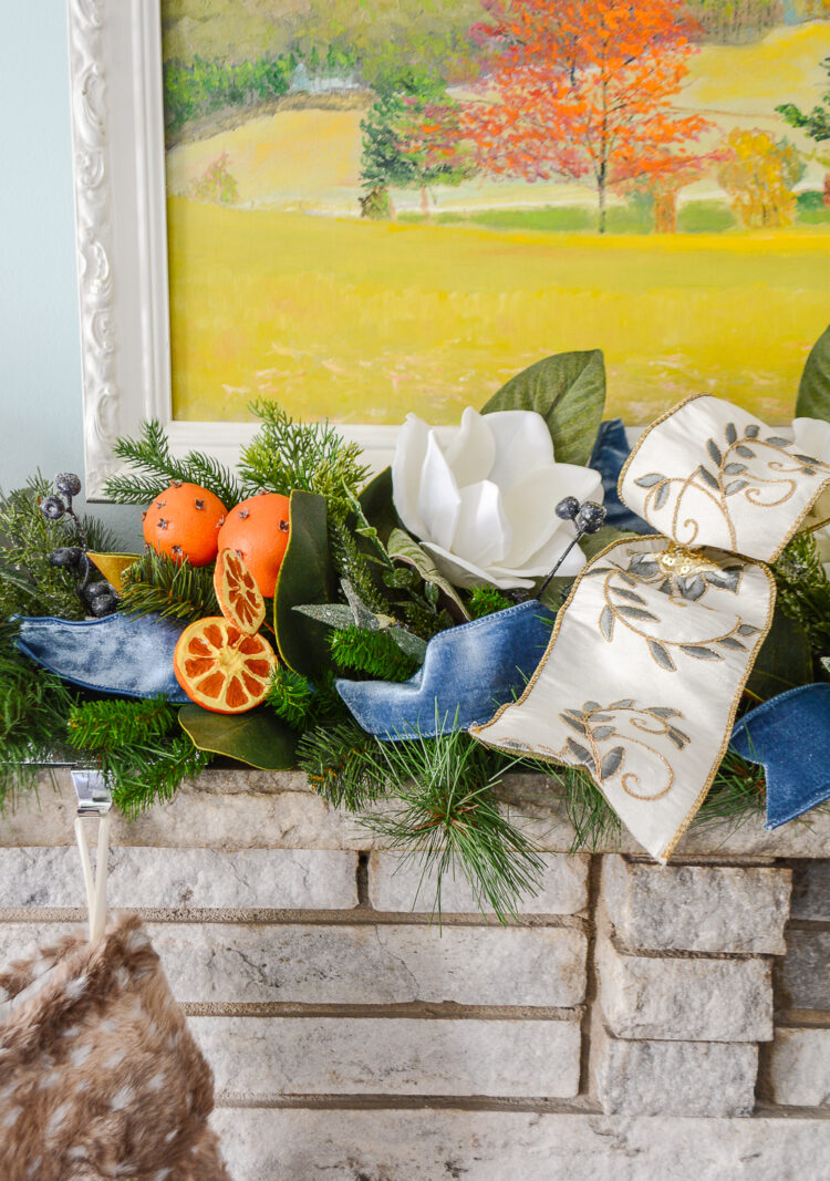 Shop this one of a kind garland for a very merry mix of magnolia, pine, orange pomanders, and ribbon for your holiday mantel!
