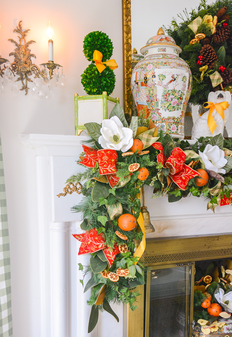 Detail view of my Williamsburg inspired Southern Christmas garland with white magnolia blooms, pine, cedar, and orange pomanders.