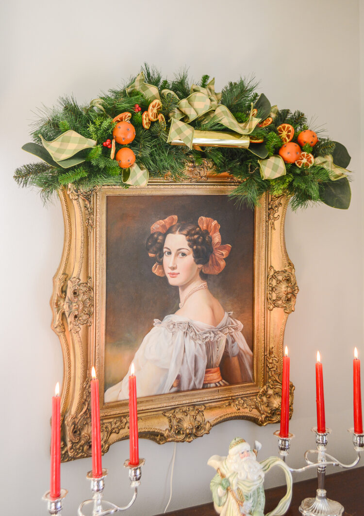 Shop this gorgeous Christmas swag inspired by Williamsburg with orange pomanders, red berries, magnolia, and a green plaid bow.