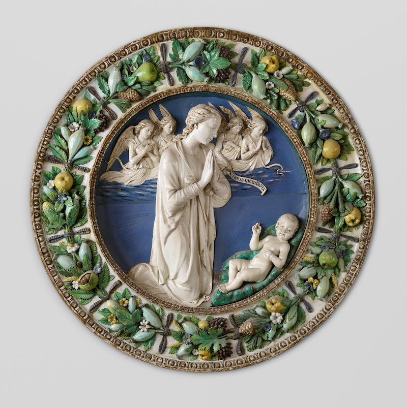 Round relief sculpture of Adoration of Christ showing wreath frame popularized by della Robbia