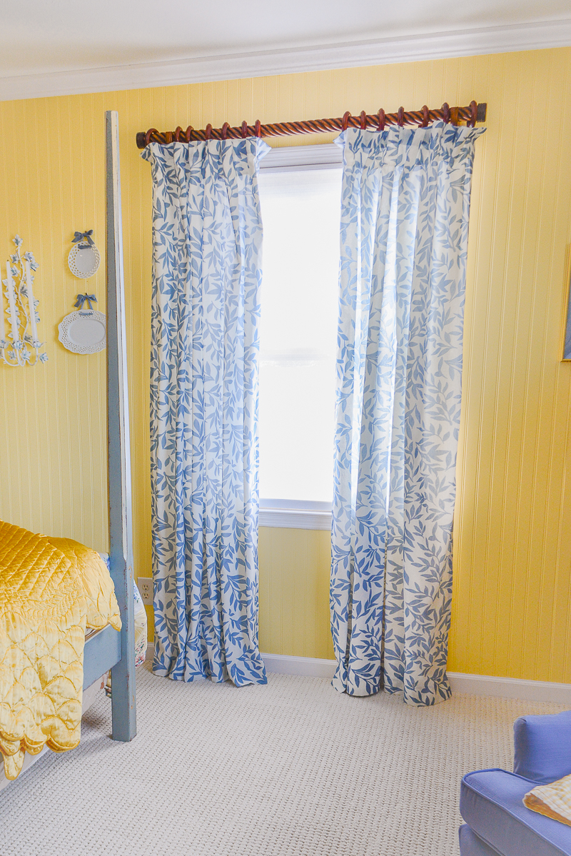 Decoberry blue and white Emily leaf curtains hung in yellow guest bedroom
