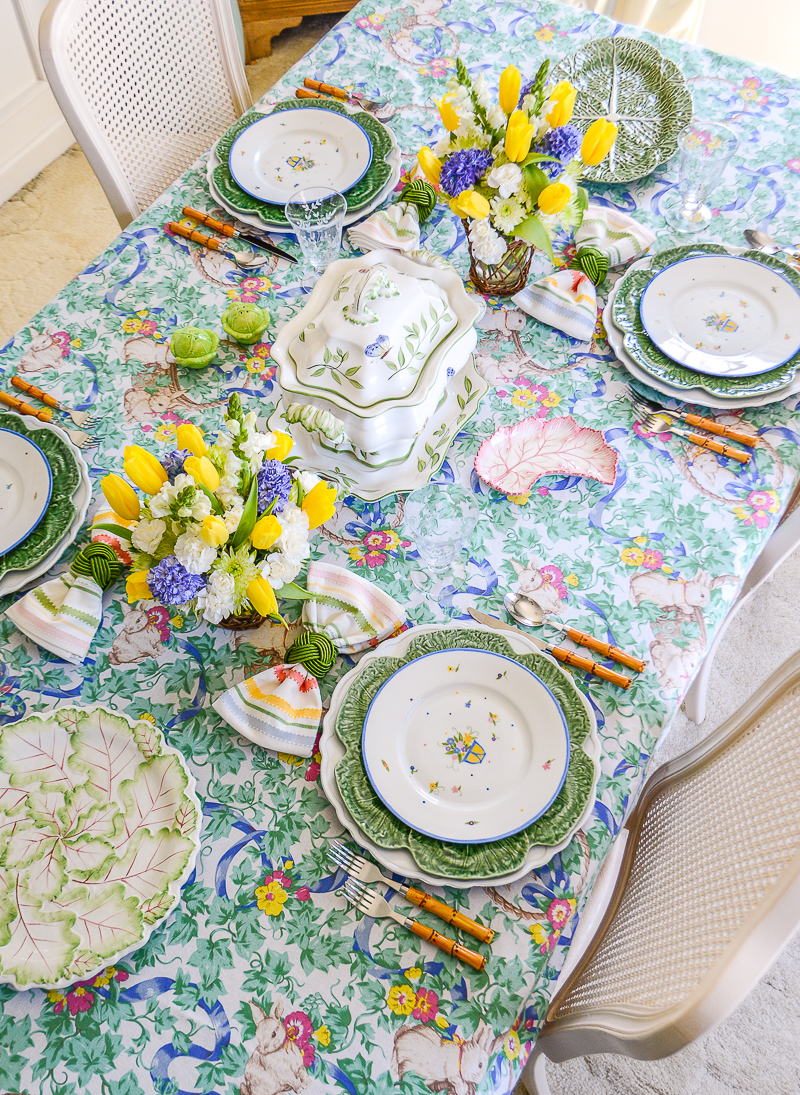 A blue, green, and yellow Easter table with Hutschenreuther Bavaria china, Bordallo Pinheiro cabbage ware, and a vintage bunny tablecloth