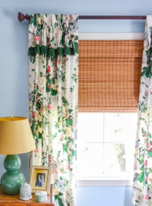 Vintage chintz curtains in bedroom against blue walls, showing my love of floral decor