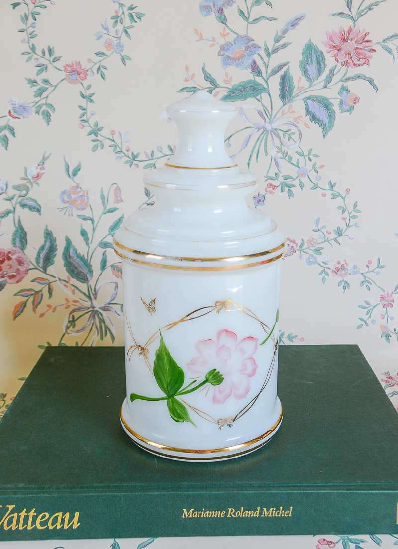 Shop this vintage apothecary jar in white satin glass with pink lotus design on Curio Collected at penderandpeony.com