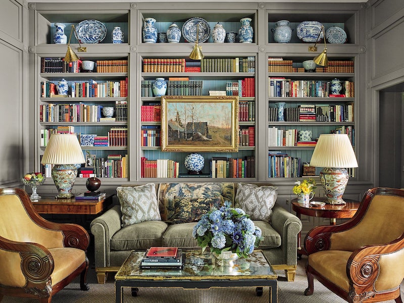 Cozy library with shelves decorated in books and blue and white porcelains in a Manhattan East Side Townhouse, Designed by Bunny Williams