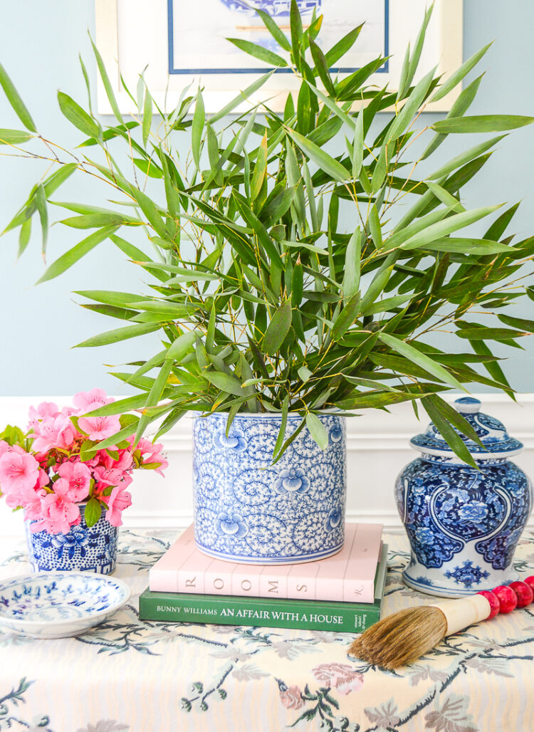 Blue and white cylinder vase with floral design.