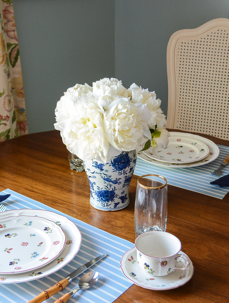 Fresh white peonies arranged in a blue and white Chinese jar on the breakfast table