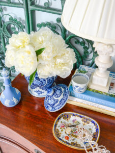 Here's why I'm picky about blue and white ceramics...Blue and white Chinese jar with white peonies on dresser with Wedgwood and marble lamp