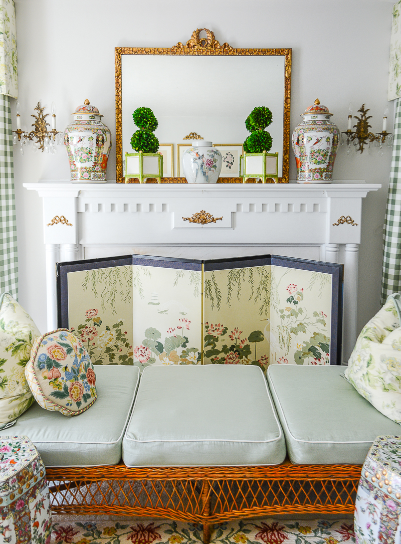 A fireplace with Chinese silk folding screen