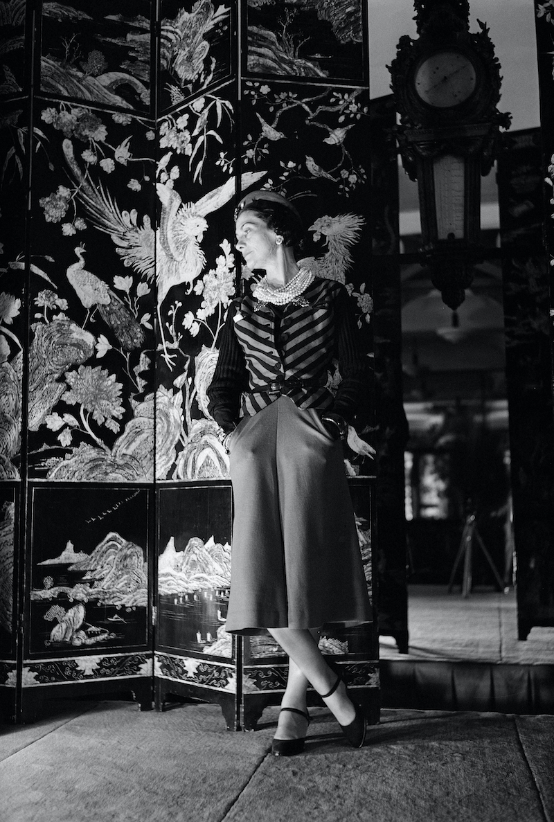 Coco Chanel in front of Coromandel screen circa 1937