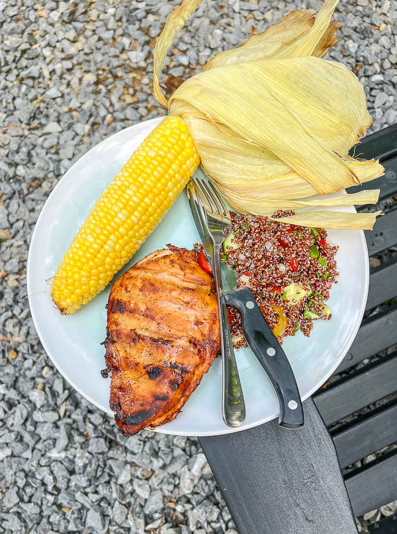 BBQ chicken, grilled corn, and quinoa salad cooked on our Glamping trip