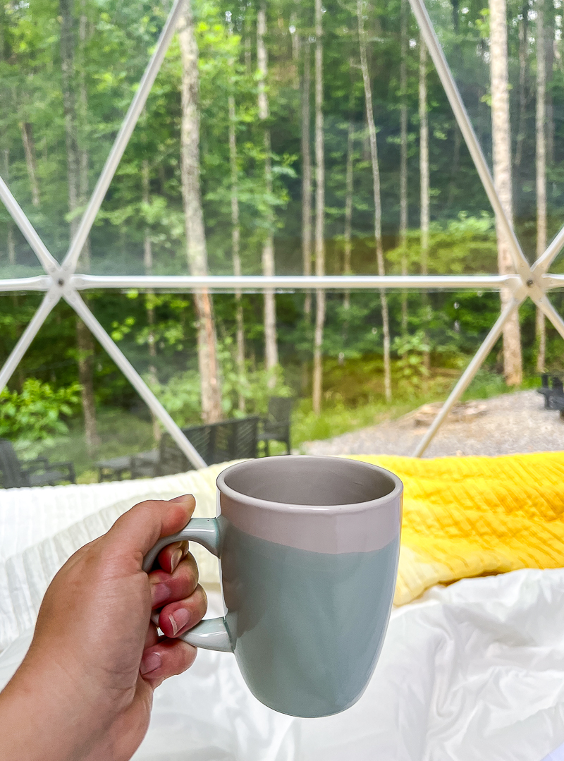 coffee wakeup call and morning light pouring into dome on glamping trip