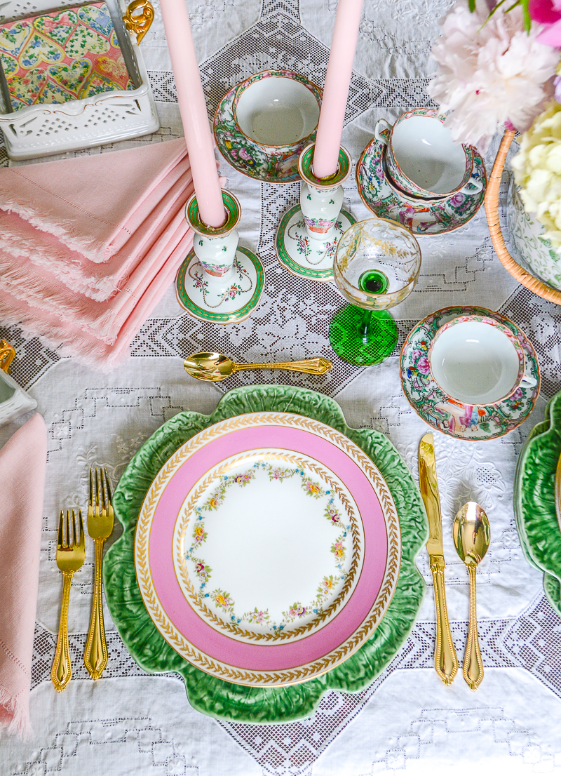 Ovington Bros. pink floral swag Limoges dinner plates on top of green cabbage ware charger in pink and green table setting