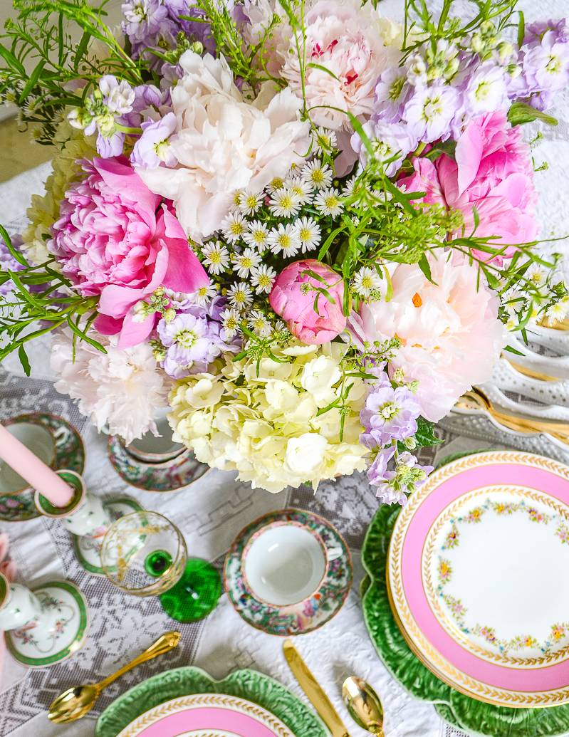 Top view of peony hydrangea arrangement with little daisies and purple stock.