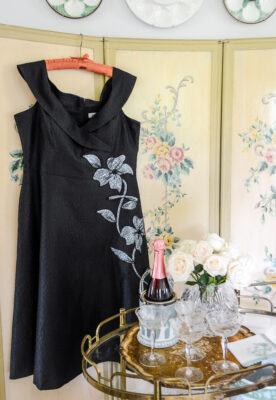 Teri Jon black off the shoulder gown hung on screen - wedding guest dress