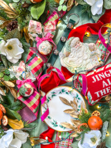Grandmillennial meet Williamsburg Christmas look - flatlay of ribbon, ornaments, dishes, and decor