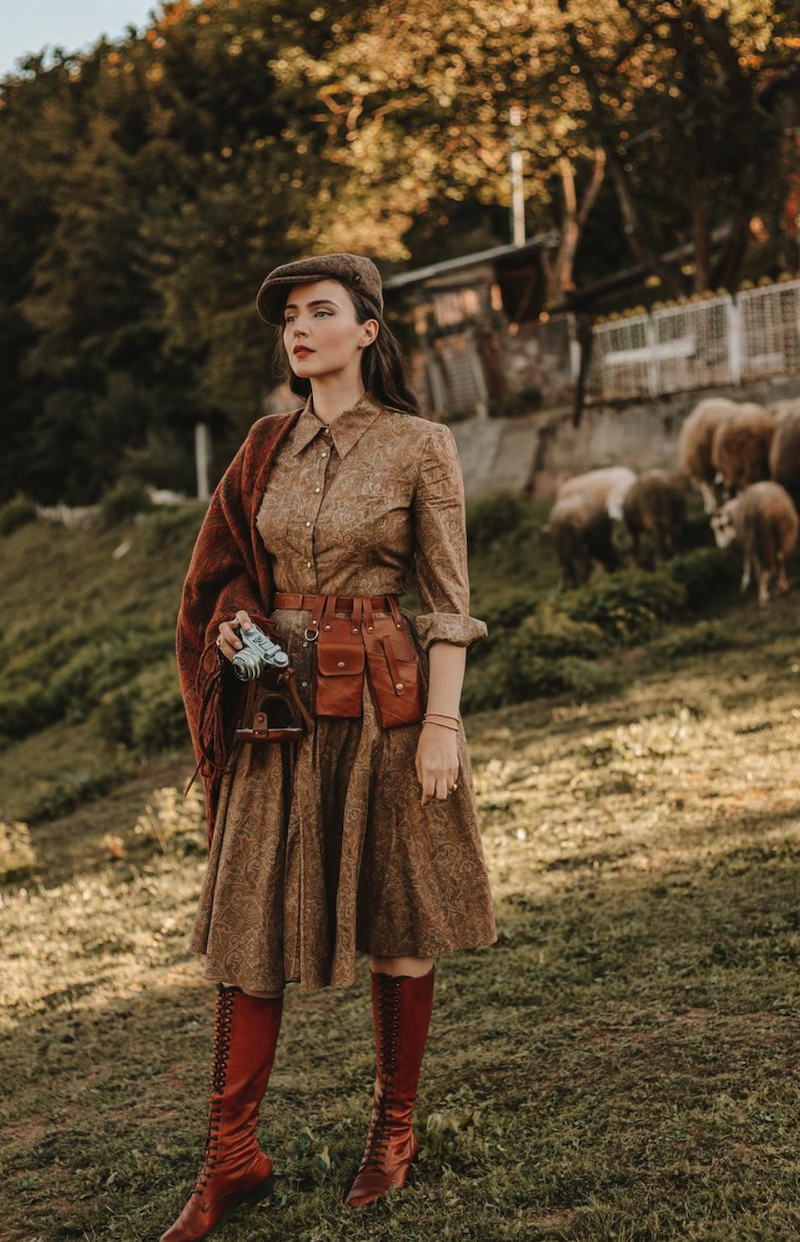 Idda Van Munster in brown outfit in field with sheep - fall