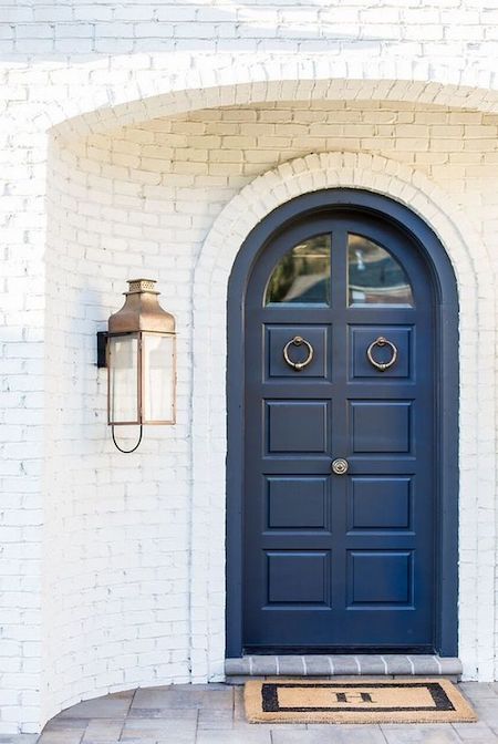 blue arched door with too big side light