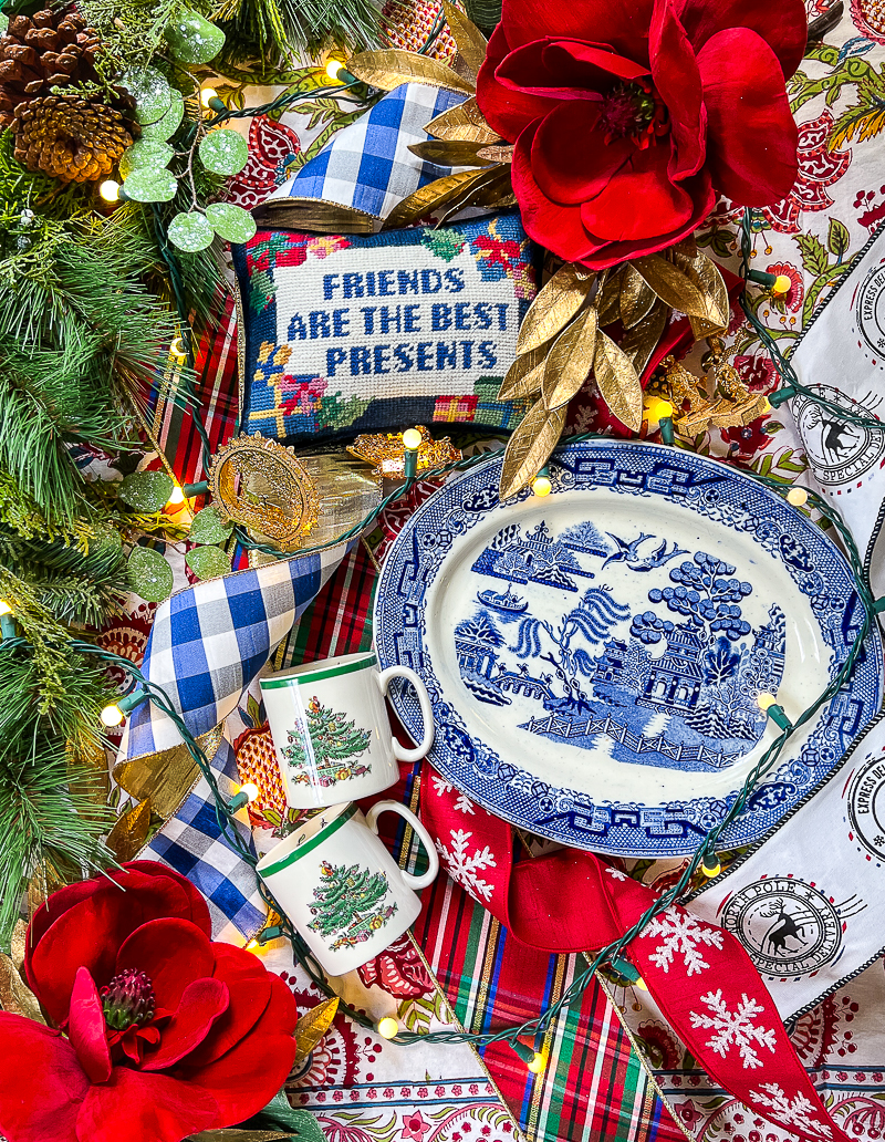 Preppy Chinoiserie Christmas look for garland kits in a traditional Ralph Lauren style - flatlay with dishes, ribbon, decor, and florals