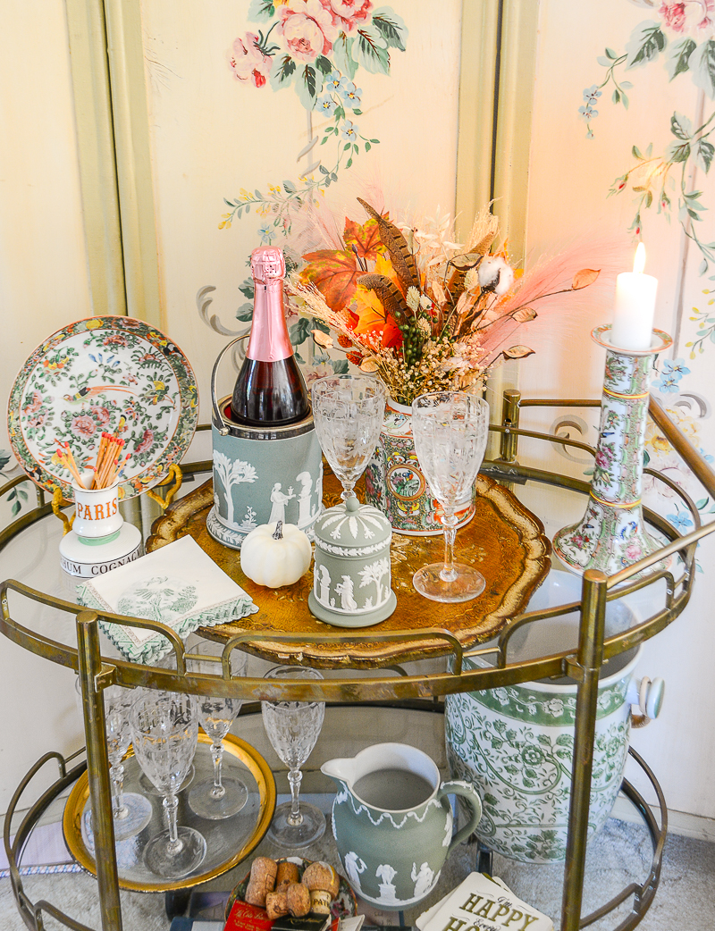 Fall living room decor on the brass bar cart with a white pumpkin and autumn floral arrangement