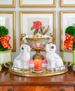 Fall decor in the living room with antiques, vintage brass, gingham ribbon, and pumpkins